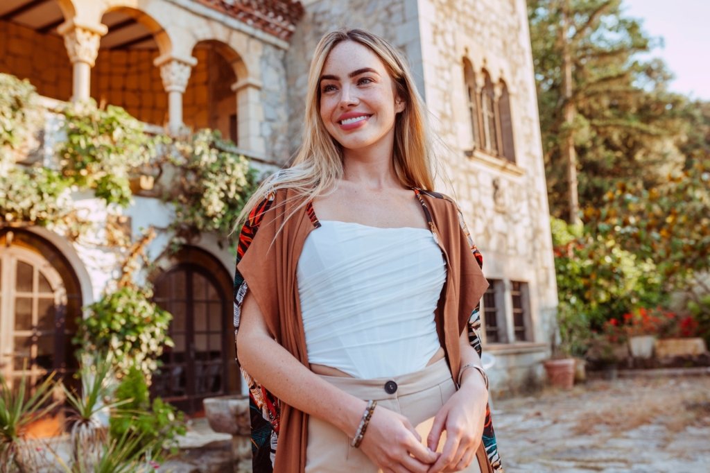 Young happy smiling beautiful woman posing at luxury villa